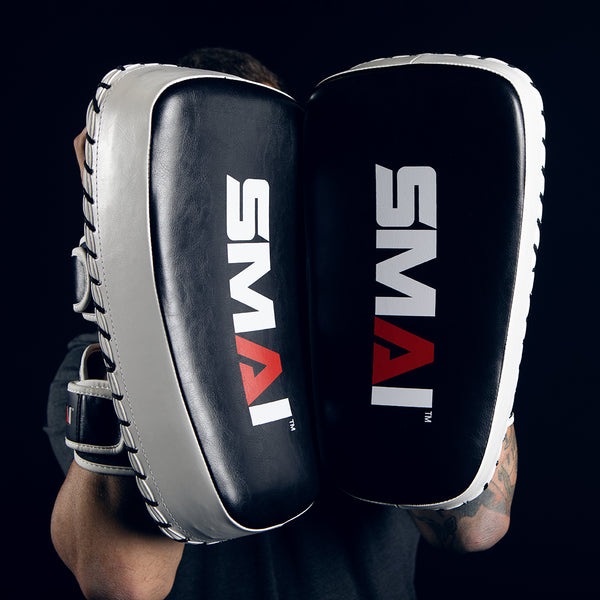 Man Holding Muay Thai Pads Facing Camera