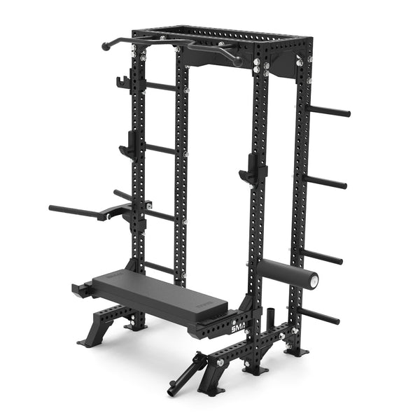 The SMAI USA Half Power Rack Ultimate Package - Vanta Series is a black metal rack with a pull-up bar, weight plate holders, safety bars, padded bench, and leg exercise attachment—perfect for compact, efficient strength training.