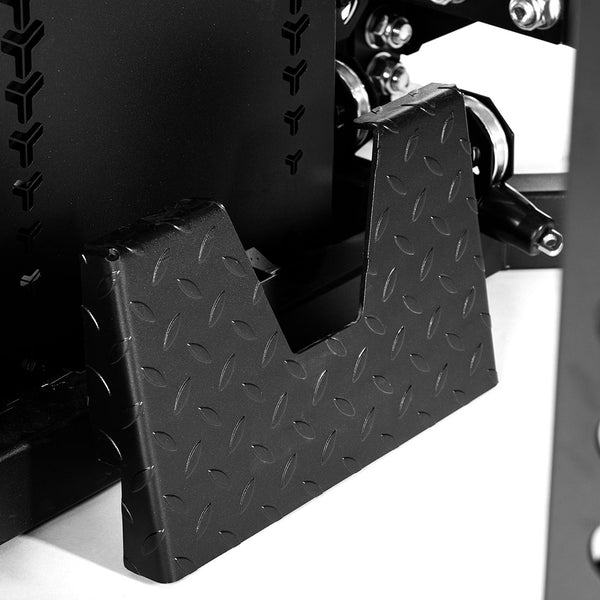 Close-up of a black diamond-patterned metal footplate with an angular cutout, attached to the SMAI USA Power Rack with Cable Machine & Accessories Pack - Vanta Series, shown on a white background.