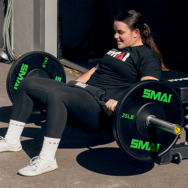Crossfit Athlete Julia Hannaford dong a barbell Hip Thrust with 25LB SMAI Bumper Plates