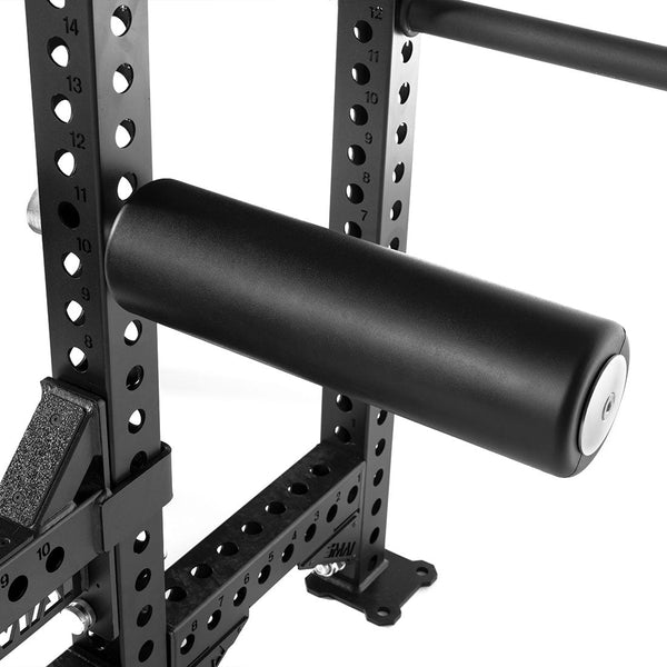 Close-up of the SMAI USA Leg Roller Attachment - Vanta Series, shown in black and secured to a metal rack with multiple holes and numbered markings for customizable workout positions.