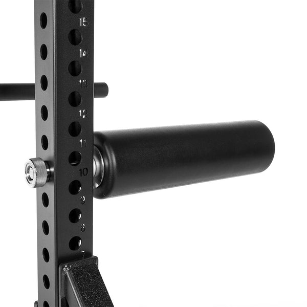 Close-up of the SMAI USA Leg Roller Attachment - Vanta Series mounted on a squat rack, showing numbered holes for easy height adjustment.