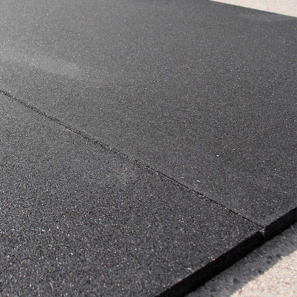 Two pieces of rubber gym flooring tile on floor flush join