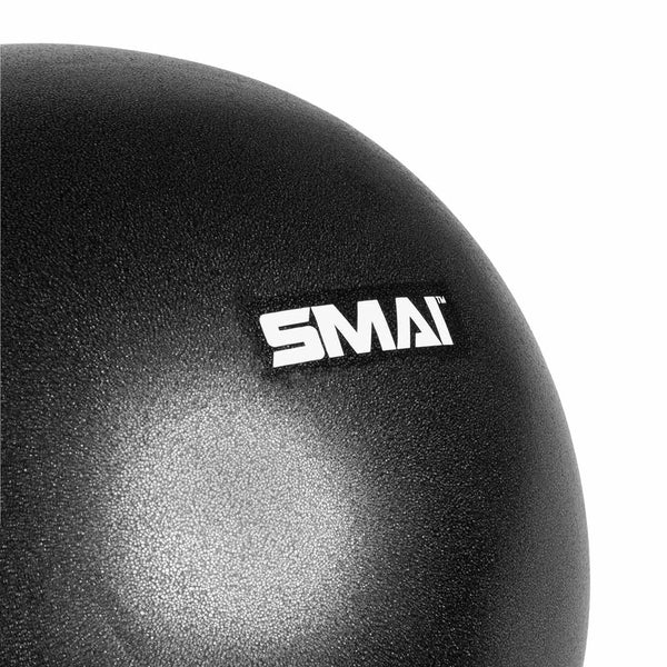 Close-up of the 11-inch black Pilates Ball from SMAI USA featuring a white "SMAI" logo. Its textured, slightly reflective surface is perfect for balance training and core strengthening exercises.