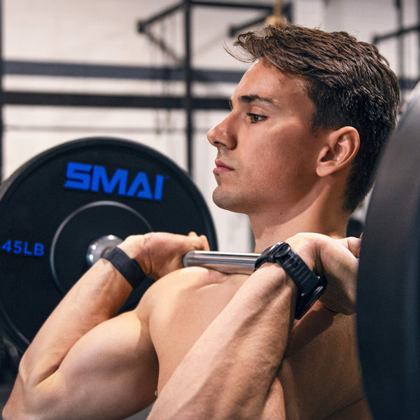 Man lifting with 45LB SMAI Bumper Plates