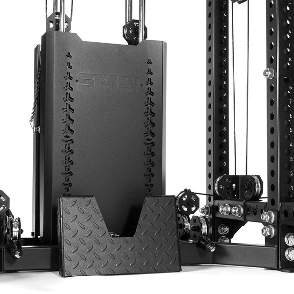 Close-up of the SMAI USA Power Rack with Cable Machine & Accessories Pack - Vanta Series, featuring a black weight stack with visible pulleys, cables, and a textured metal foot plate as part of this functional gym equipment.