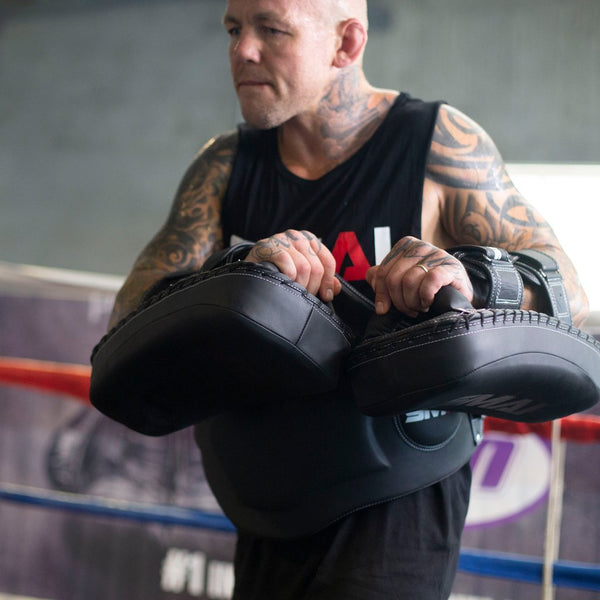 Man using Elite85 Muay Thai Belly Pad