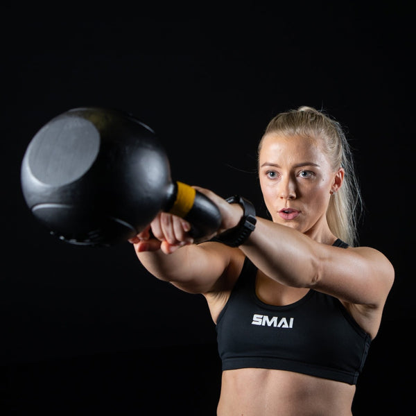 Woman swinging 40lb Cast Iron Kettlebell