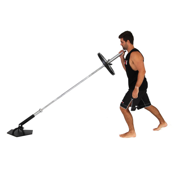 Man pushing barbell connected to a landmine trainer