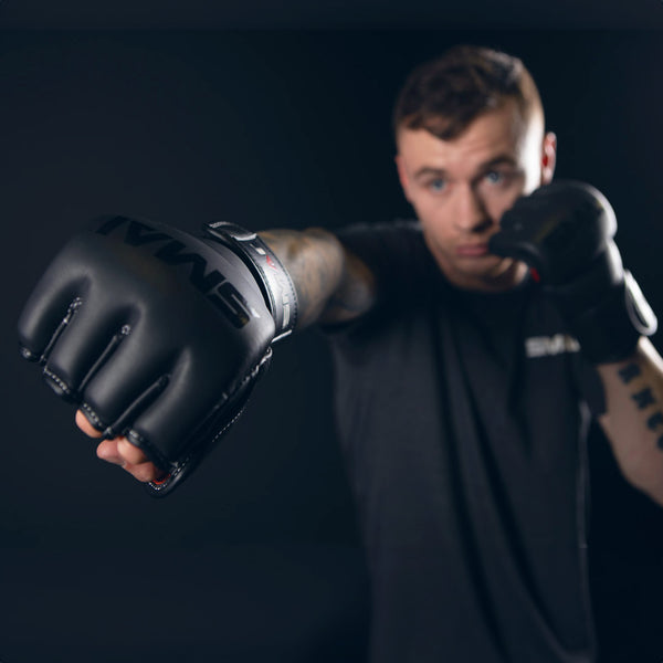 Man punching focused on Elite85 MMA Gloves