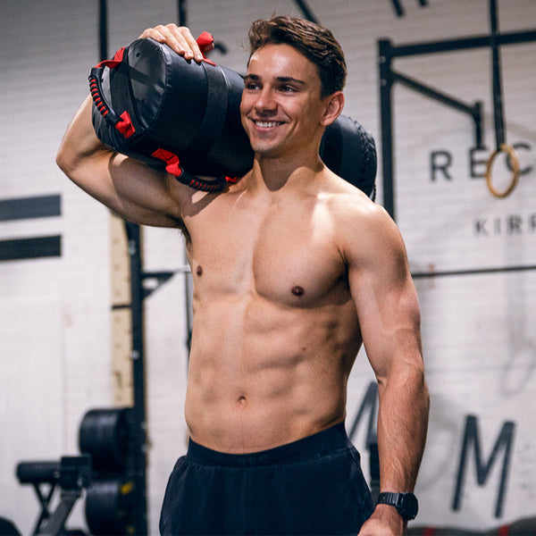 Man smiling with 40LB Core Bag on his shoulder
